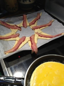 Bacon. Eggs scrambling.