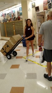Picking up her bedding packages from the campus post office. 